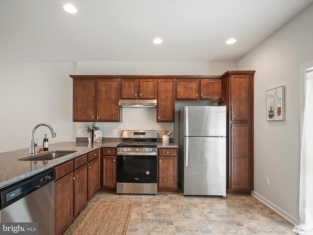 262 Norland Knoll Dr, Stephenson, VA 22656 - kitchen with appliances with stainless steel finishes, under cabinet range hood, dark stone countertops, stone finish flooring, and recessed lighting