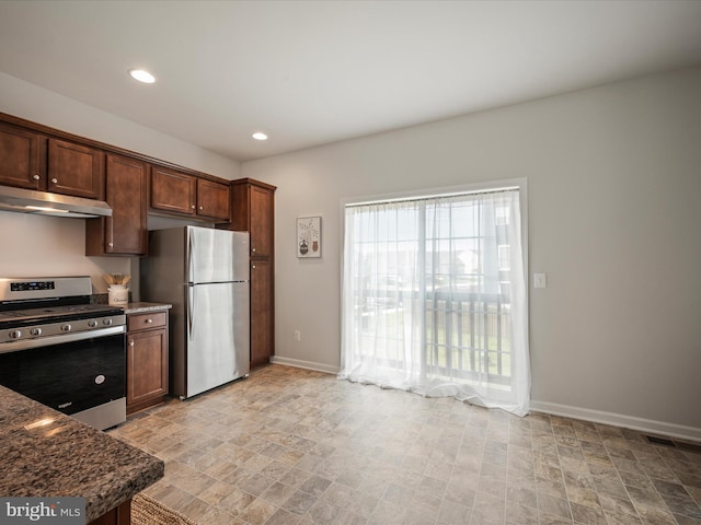 262 Norland Knoll Dr, Stephenson, VA 22656 - kitchen featuring stainless steel appliances, under cabinet range hood, stone finish floors, recessed lighting, and dark stone counters