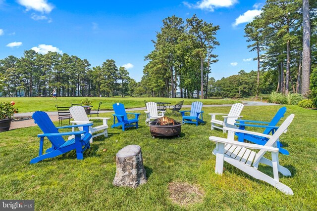 12545 River Run Ln Unit 68, Berlin, MD 21811 - view of green lawn featuring an outdoor fire pit and view of wooded area