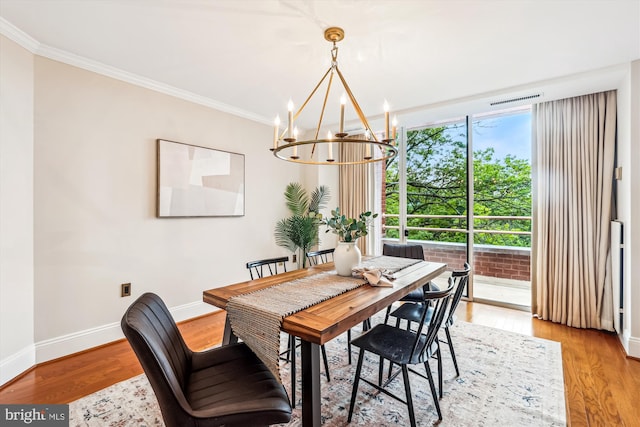 955 26th St NW Unit 512, Washington, DC 20037 - dining space featuring a chandelier, crown molding, and light wood finished floors