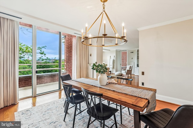 955 26th St NW Unit 512, Washington, DC 20037 - dining area featuring a chandelier, ornamental molding, and light wood-style floors