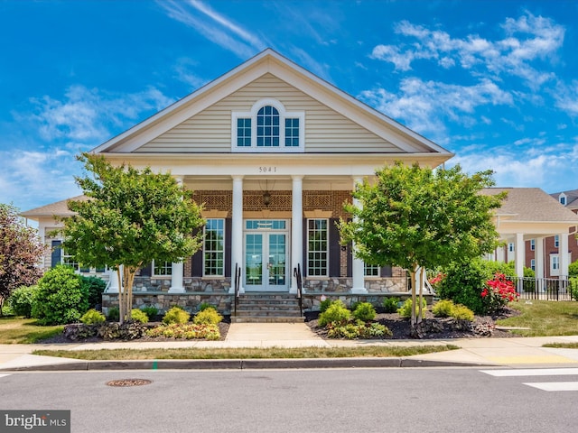 7114 Proclamation Pl, Frederick, MD 21703 - greek revival inspired property with covered porch, french doors, and stone siding
