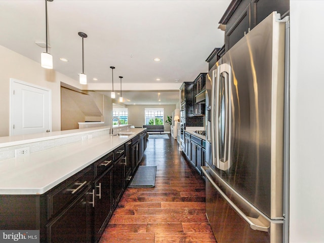 7114 Proclamation Pl, Frederick, MD 21703 - kitchen with appliances with stainless steel finishes, a sink, dark wood-style flooring, recessed lighting, and light countertops