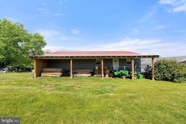 321 Garlic Hollow Rd, Edinburg, VA 22824 - back of house featuring metal roof, an outbuilding, and a lawn