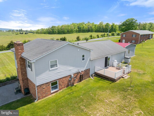 321 Garlic Hollow Rd, Edinburg, VA 22824 - back of property with a deck, a lawn, a chimney, and brick siding