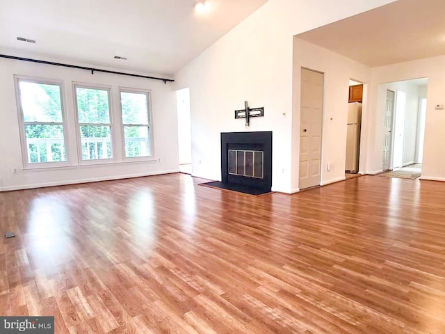 20072 Appledowre Cir Unit 237, Germantown, MD 20876 - unfurnished living room with light wood finished floors, a fireplace with flush hearth, and baseboards