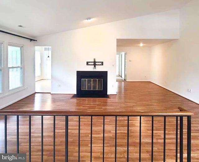 20072 Appledowre Cir Unit 237, Germantown, MD 20876 - unfurnished living room featuring wood finished floors, a fireplace with flush hearth, baseboards, and vaulted ceiling