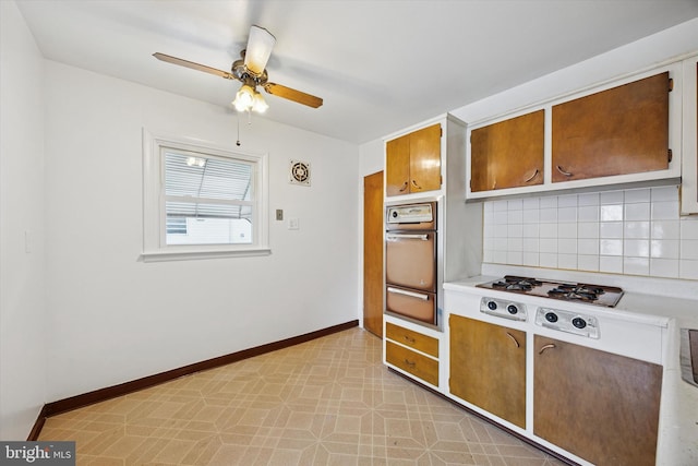 1069 Surrey Rd, Philadelphia, PA 19115 - kitchen with wall oven, a warming drawer, a ceiling fan, backsplash, and light countertops