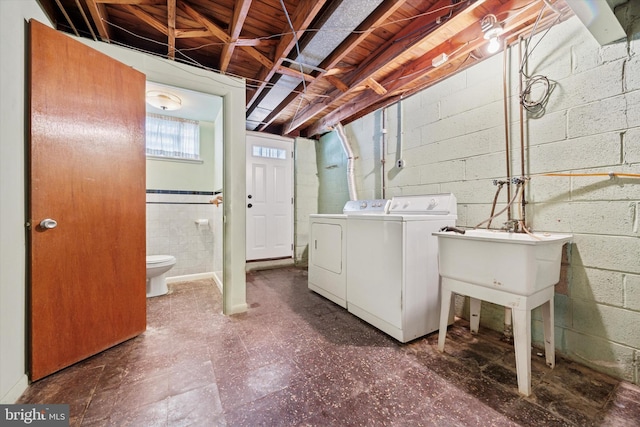 1069 Surrey Rd, Philadelphia, PA 19115 - washroom featuring washing machine and clothes dryer, tile patterned floors, and concrete block wall