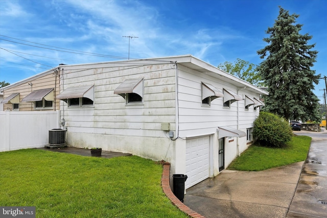 1069 Surrey Rd, Philadelphia, PA 19115 - view of home's exterior with a lawn, cooling unit, concrete driveway, and a garage