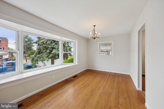 1069 Surrey Rd, Philadelphia, PA 19115 - unfurnished room featuring a chandelier, baseboards, and light wood-type flooring