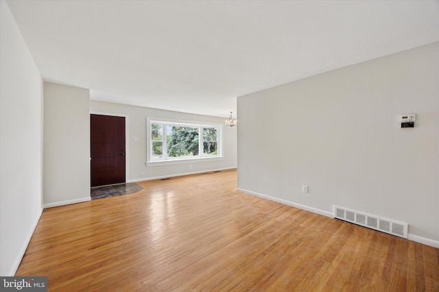 1069 Surrey Rd, Philadelphia, PA 19115 - empty room with a chandelier, light wood-type flooring, and baseboards