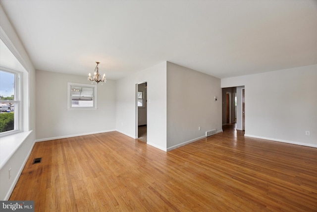 1069 Surrey Rd, Philadelphia, PA 19115 - unfurnished room with a chandelier, light wood-style floors, and baseboards