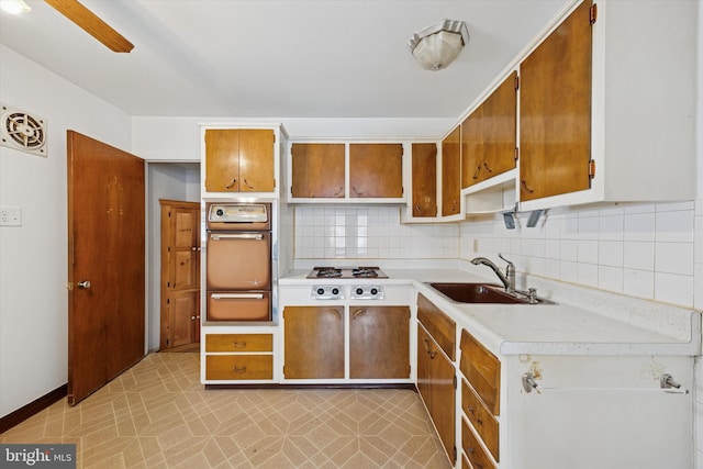 1069 Surrey Rd, Philadelphia, PA 19115 - kitchen featuring wall oven, a sink, a warming drawer, light countertops, and gas cooktop