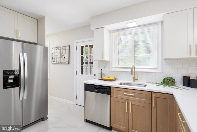 517 Worcester, Towson, MD 21286 - kitchen featuring appliances with stainless steel finishes, a sink, light countertops, and backsplash