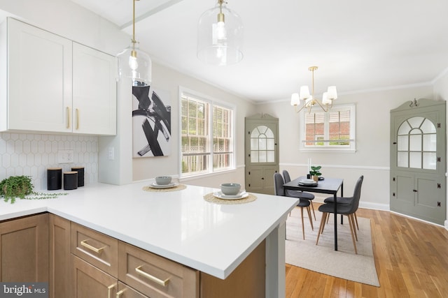 517 Worcester, Towson, MD 21286 - kitchen with plenty of natural light, light wood-style floors, light countertops, ornamental molding, and a chandelier