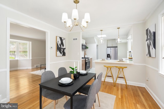 517 Worcester, Towson, MD 21286 - dining space featuring light wood-style flooring, a chandelier, baseboards, and crown molding