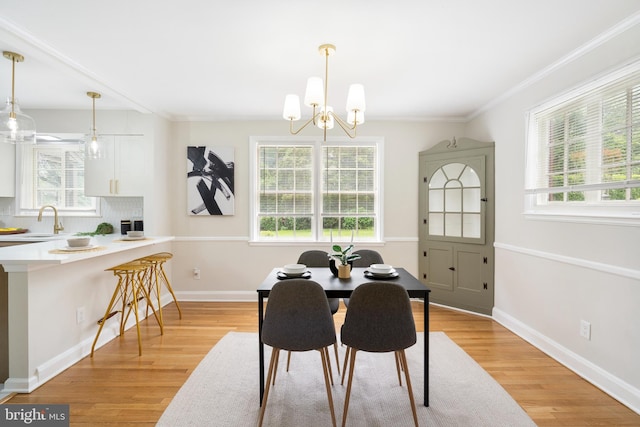 517 Worcester, Towson, MD 21286 - dining space with a chandelier, light wood-type flooring, plenty of natural light, ornamental molding, and baseboards