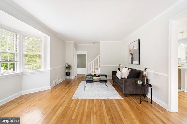 517 Worcester, Towson, MD 21286 - living area featuring light wood finished floors, stairs, crown molding, baseboards, and a baseboard heating unit