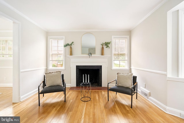 517 Worcester, Towson, MD 21286 - sitting room with wood finished floors, a fireplace with flush hearth, baseboards, and ornamental molding