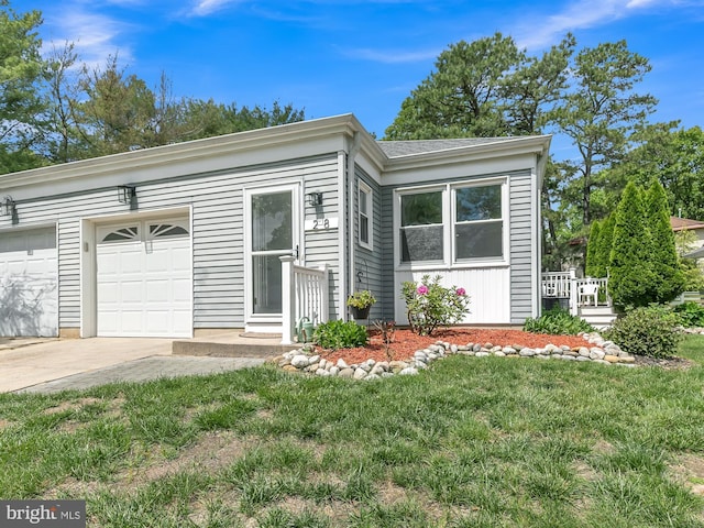 28 Sycamore Rd Unit 45, Manahawkin, NJ 08050 - view of front facade with driveway, an attached garage, and a front yard