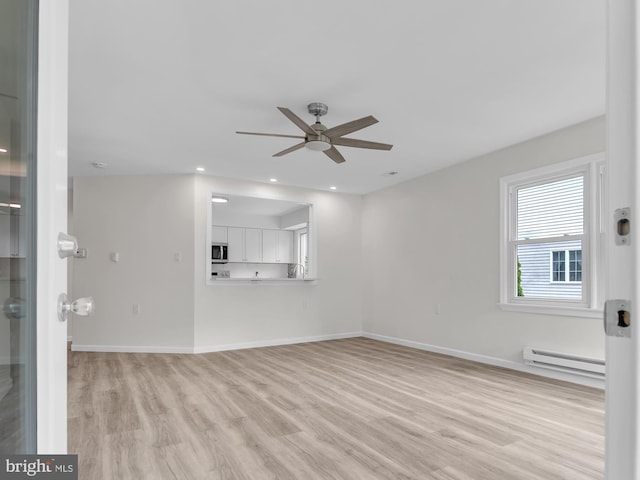28 Sycamore Rd Unit 45, Manahawkin, NJ 08050 - unfurnished living room featuring baseboard heating, ceiling fan, light wood-style flooring, baseboards, and recessed lighting