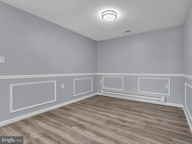 28 Sycamore Rd Unit 45, Manahawkin, NJ 08050 - spare room featuring wood finished floors, a baseboard radiator, and baseboards