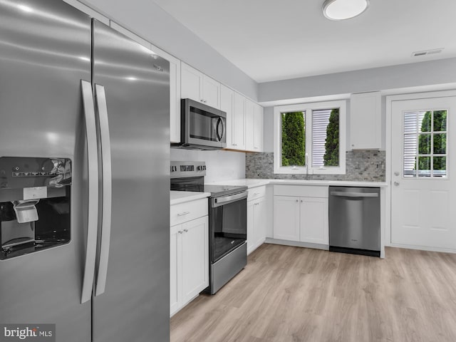 28 Sycamore Rd Unit 45, Manahawkin, NJ 08050 - kitchen featuring appliances with stainless steel finishes, healthy amount of natural light, light countertops, and decorative backsplash