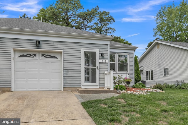 28 Sycamore Rd Unit 45, Manahawkin, NJ 08050 - view of front of property featuring concrete driveway, a front lawn, a garage, and a shingled roof