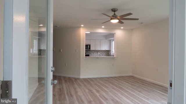 28 Sycamore Rd Unit 45, Manahawkin, NJ 08050 - empty room with a ceiling fan, light wood-style floors, recessed lighting, baseboards, and a sink