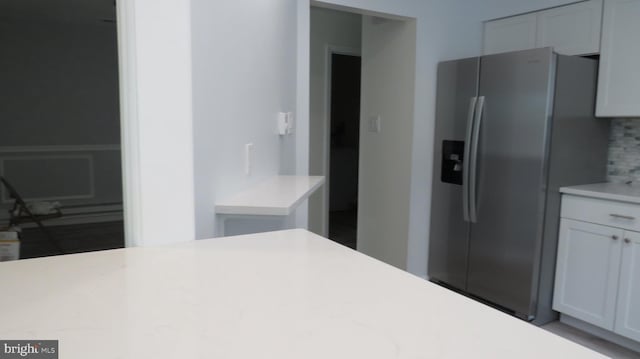 28 Sycamore Rd Unit 45, Manahawkin, NJ 08050 - kitchen featuring stainless steel refrigerator with ice dispenser, light countertops, tasteful backsplash, and white cabinets