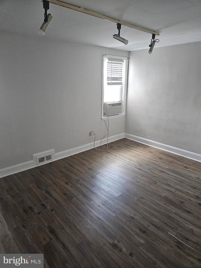 423 Gusryan St, Baltimore, MD 21224 - spare room featuring dark wood-style floors, cooling unit, and baseboards