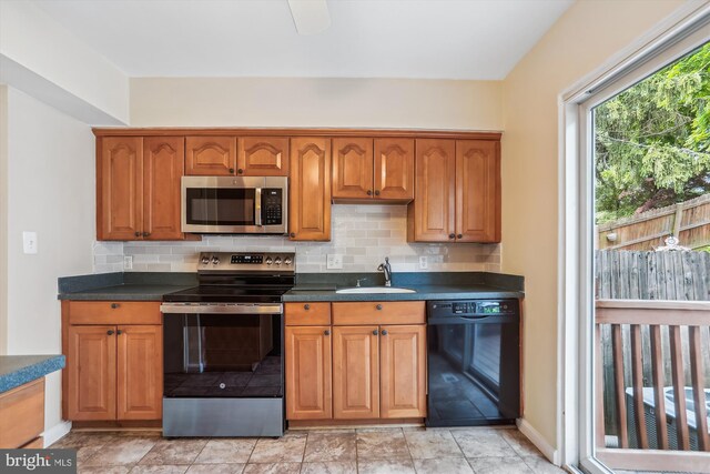 19918 Wyman Way, Germantown, MD 20874 - kitchen with stainless steel appliances, a sink, tasteful backsplash, and dark countertops