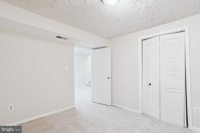 19918 Wyman Way, Germantown, MD 20874 - unfurnished bedroom featuring light carpet, a textured ceiling, a closet, and baseboards