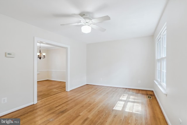 19918 Wyman Way, Germantown, MD 20874 - unfurnished room with light wood finished floors, a chandelier, baseboards, and a ceiling fan