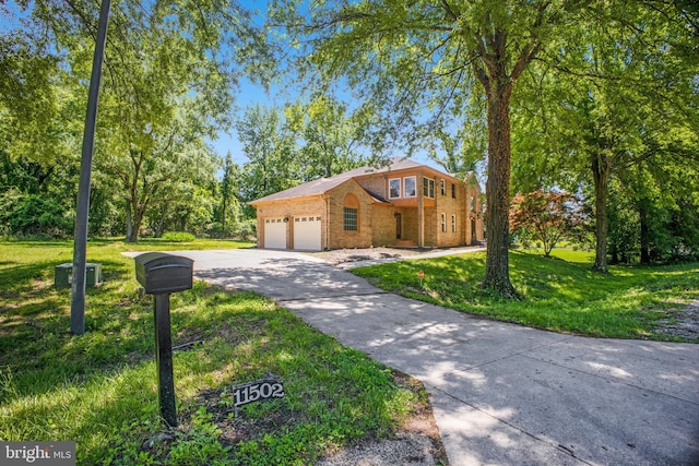 11502 Riverview Rd, Fort Washington, MD 20744 - view of front of home with a garage, brick siding, a front lawn, and driveway