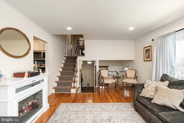 44 Rolling Ln, Hamilton, NJ 08690 - living area featuring light wood-style flooring, stairway, recessed lighting, and a warm lit fireplace