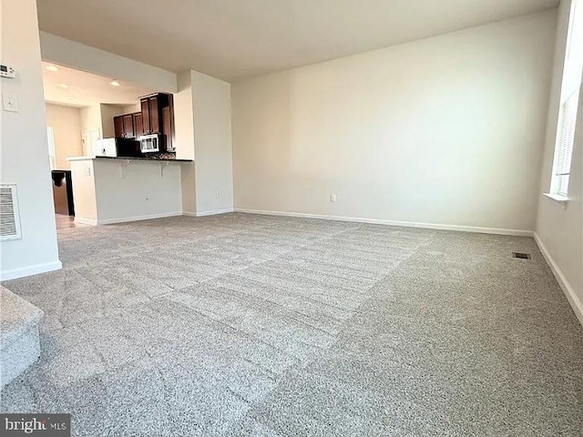 4118 Votive, Williamsburg, VA 23188 - unfurnished living room featuring light carpet and baseboards