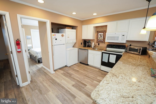 17 139th St Unit 101, Ocean City, MD 21842 - kitchen featuring white appliances, estacked washer and dryer, ornamental molding, white cabinets, and recessed lighting