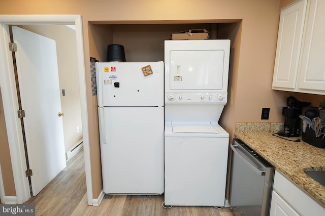 17 139th St Unit 101, Ocean City, MD 21842 - laundry area with stacked washing machine and dryer, light wood-style flooring, and a baseboard radiator
