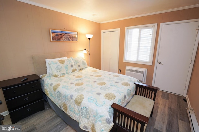 17 139th St Unit 101, Ocean City, MD 21842 - bedroom featuring wood finished floors, ornamental molding, a baseboard radiator, a wall mounted AC, and a closet