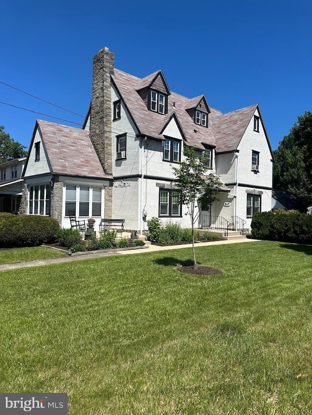 647 Aronimink Pl, Drexel Hill, PA 19026 - view of front facade with a chimney, a front lawn, and a high end roof