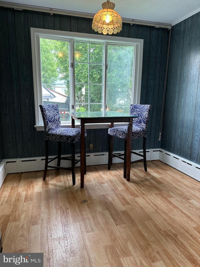 647 Aronimink Pl, Drexel Hill, PA 19026 - dining room featuring light wood-style floors, healthy amount of natural light, wood walls, and crown molding