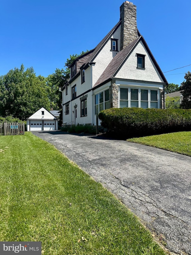 647 Aronimink Pl, Drexel Hill, PA 19026 - view of front of house with a garage, a front yard, a chimney, and stone siding