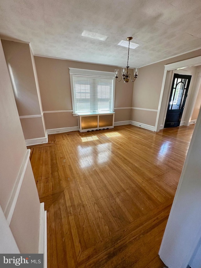 647 Aronimink Pl, Drexel Hill, PA 19026 - unfurnished dining area featuring a chandelier, healthy amount of natural light, and wood finished floors