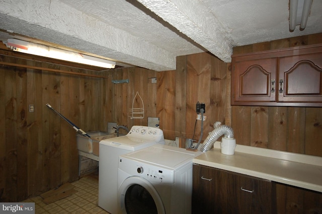 19104 Roman Way, Gaithersburg, MD 20886 - laundry room featuring cabinet space, wooden walls, light floors, washing machine and dryer, and a textured ceiling