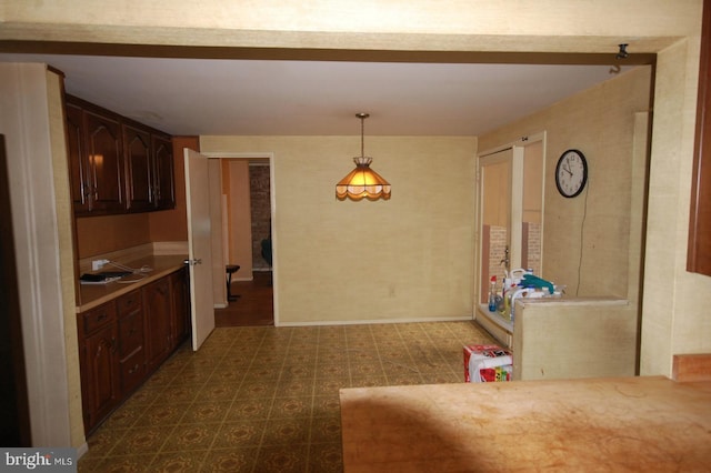 19104 Roman Way, Gaithersburg, MD 20886 - kitchen featuring dark floors, light countertops, decorative light fixtures, baseboards, and dark brown cabinets
