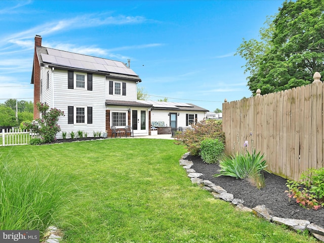 18 Alden Ln, Lebanon, PA 17042 - rear view of property with a chimney, french doors, roof mounted solar panels, and a patio area