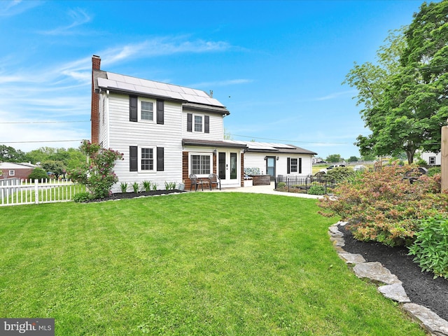 18 Alden Ln, Lebanon, PA 17042 - rear view of property featuring french doors, a chimney, a patio, and roof mounted solar panels
