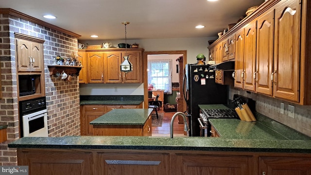 711 Tristan Trl, Chambersburg, PA 17202 - kitchen with oven, range with gas stovetop, a center island, tasteful backsplash, and dark countertops